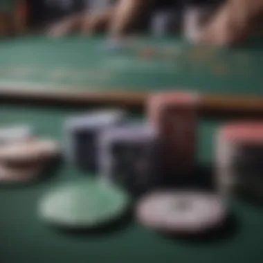 Close-up of poker chips and cards on a table during a game.